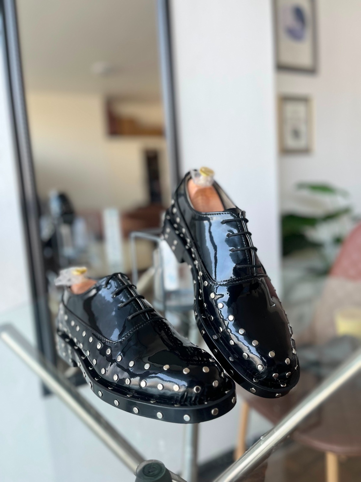 Black patent studded dress shoes on display