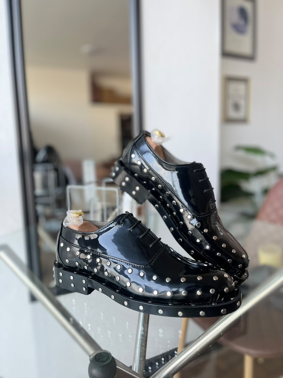 Side view of black patent studded dress shoes